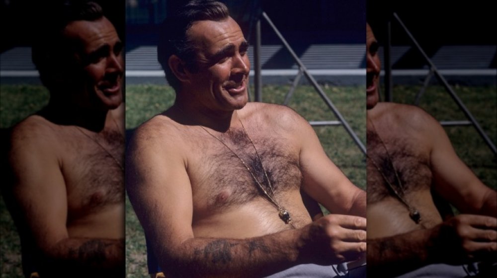 Sean Connery shows off his tattoos while relaxing on the set of Diamonds are Forever in 1971