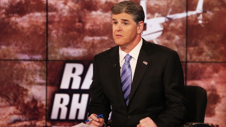 Sean Hannity seated at desk