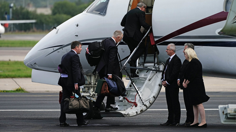 King Charles' staff loads a plane with his bags