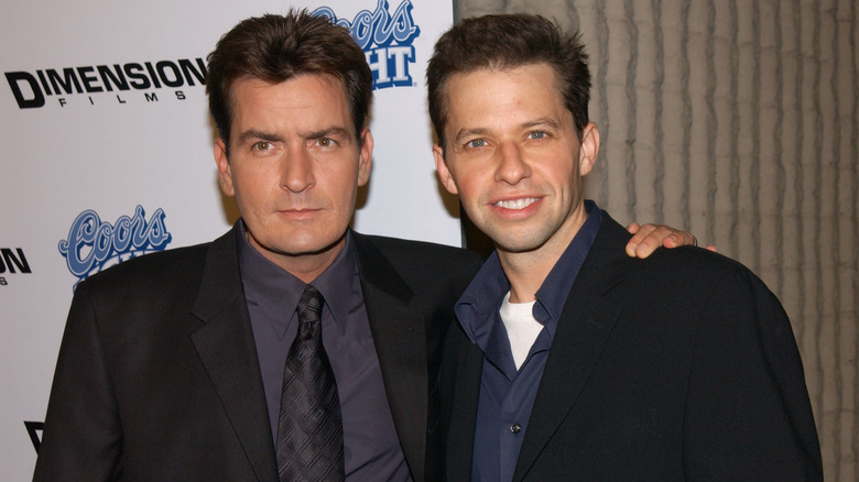 Charlie Sheen with his arm around Jon Cryer's shoulders