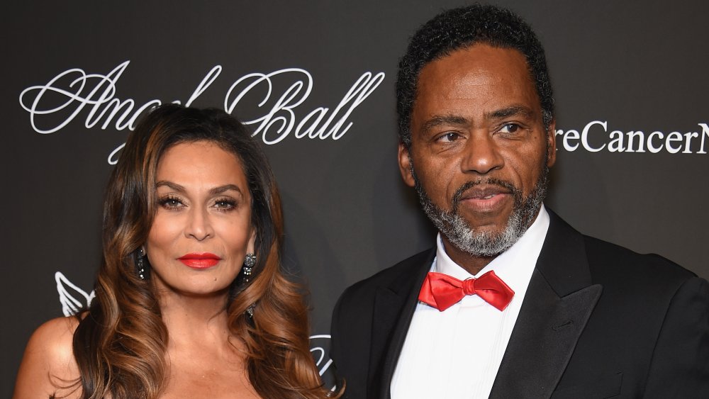 Tina Knowles-Lawson and Richard Lawson posing together, both with serious expressions