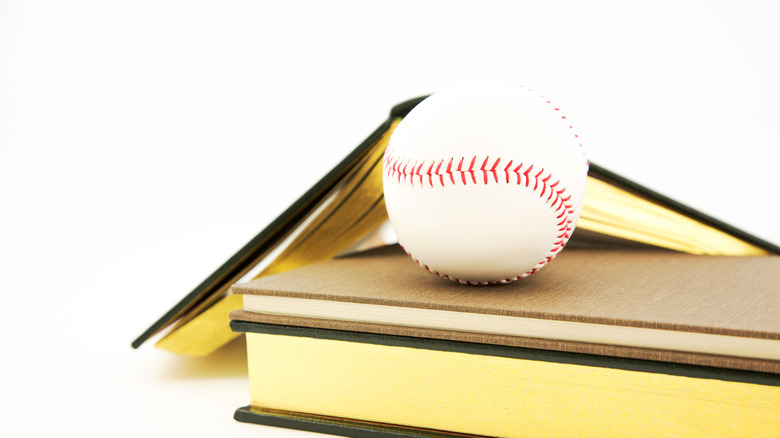 Baseball on top of books