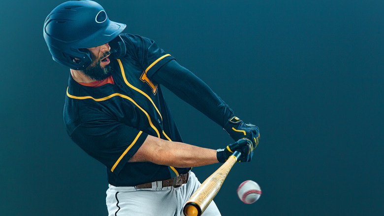 Baseball player hitting ball 