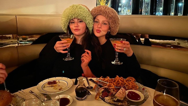 Selena Gomez and Nicola Peltz wear matching hats at restaurant