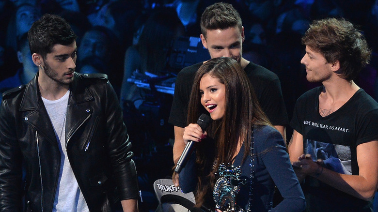 Selena Gomez talking onstage with One Direction