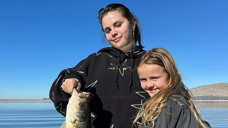 Selena Gomez and Gracie Teefey smiling with fish