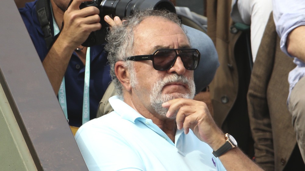 Ion Tiriac sitting in the stands