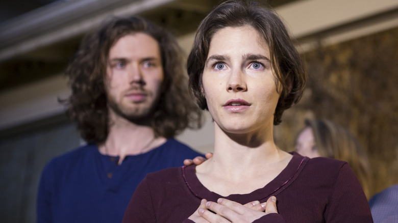 Amanda Knox with hands on chest 