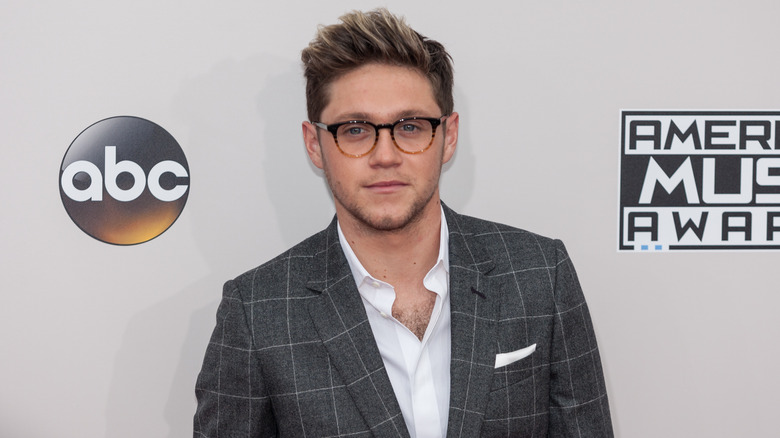 Niall Horan in glasses and suit 