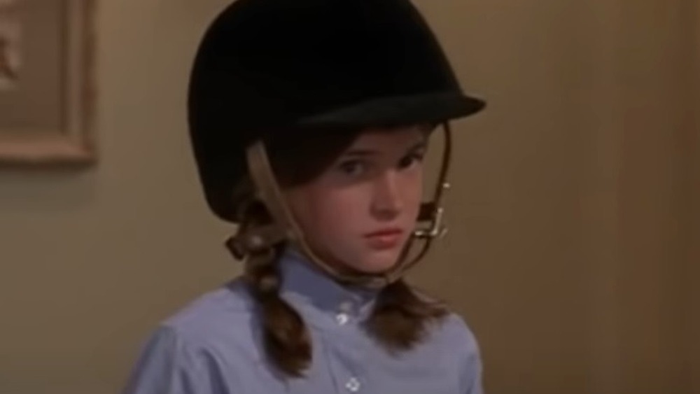 Shailene Woodley as a child wearing a horseback riding helmet