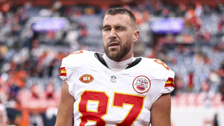 Travis Kelce winking in uniform