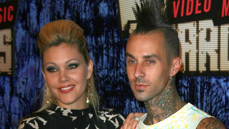 Shanna Moakler and Travis Barker posing