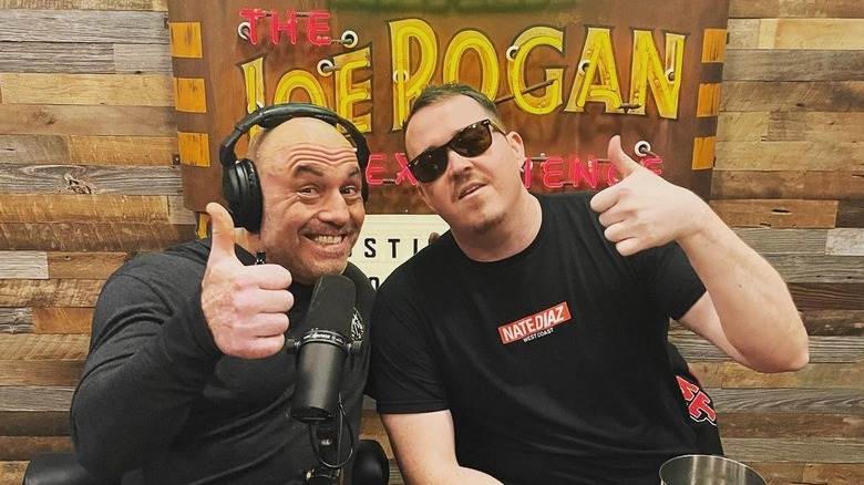 Shane Gillis and Joe Rogan giving thumbs-up