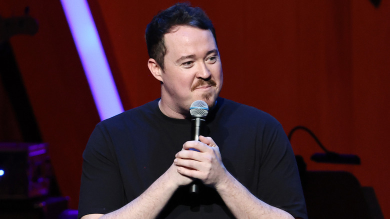 Shane Gillis performing stand-up with microphone