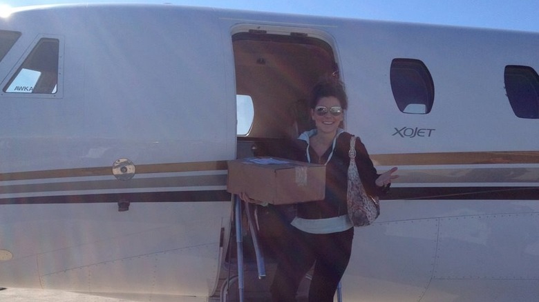 Shania Twain posing with a private jet