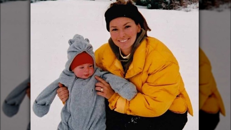 Shania Twain holding up her baby, Eja Lange, in the snow