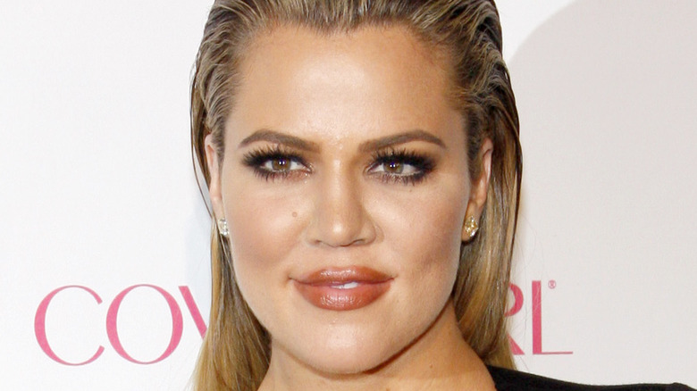 Khloe Kardashian smiles at an event