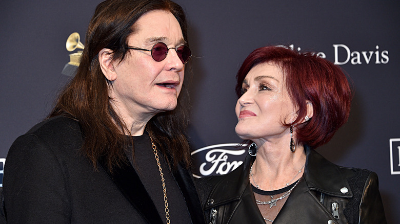 Sharon Osbourne smiling at Ozzy Osbourne talking