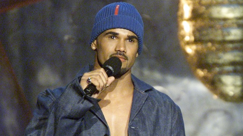 Shemar Moore holding mic