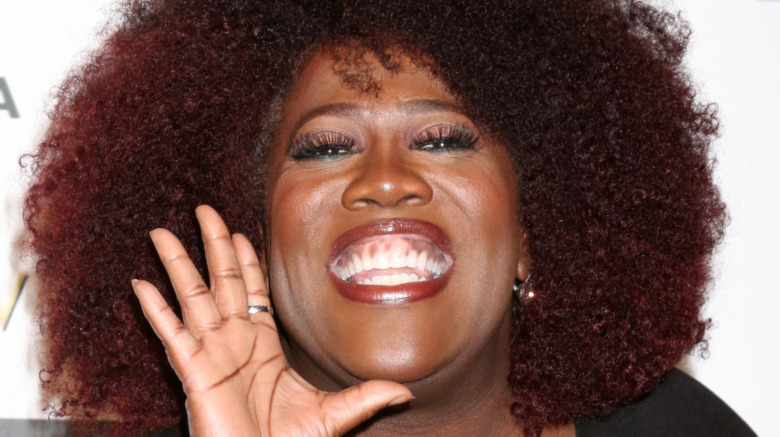 Sheryl Underwood smiling at a red carpet event