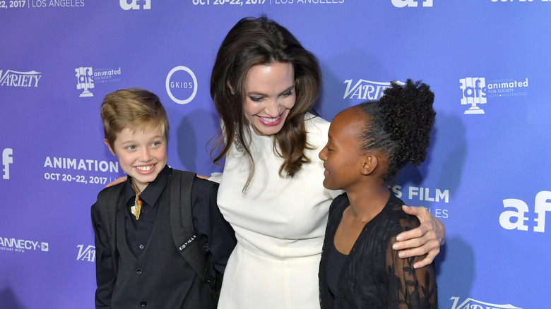 Angelina Jolie posing with Shiloh and Zahara