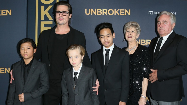 Shiloh Jolie-Pitt wearing suit with her family