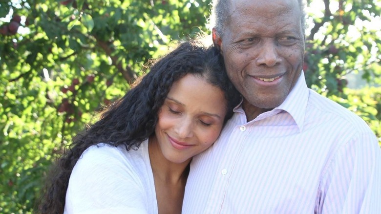 Sydney Poitier resting head on shoulder of her father