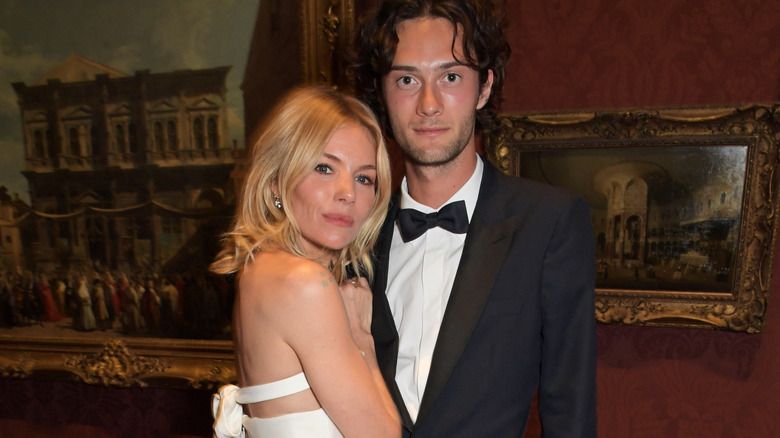 Sienna Miller and Oli Green embrace  