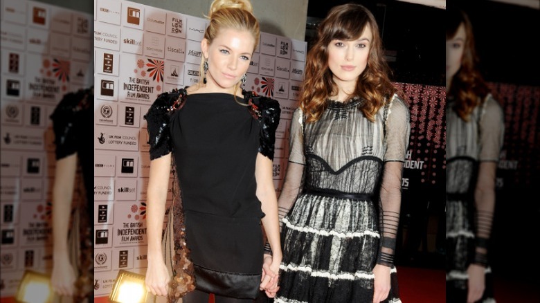 Sienna Miller holds hands with Keira Knightley