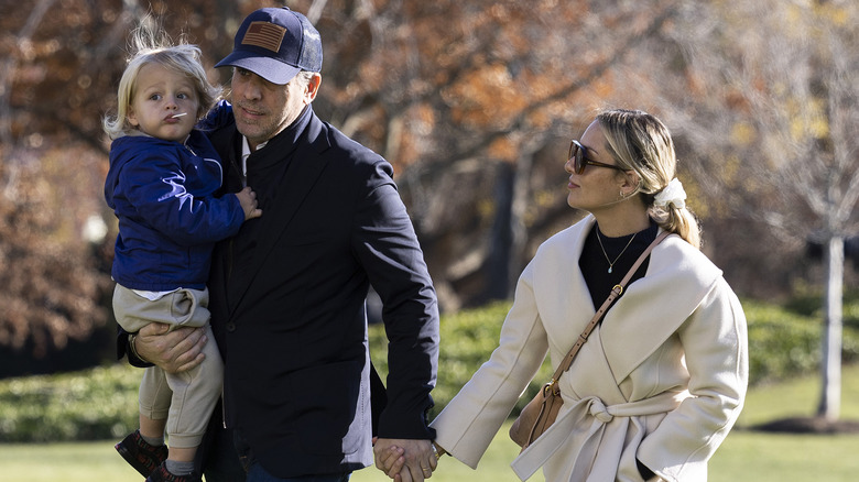 Hunter Biden and Melissa hold hands as he carries their son, Beau