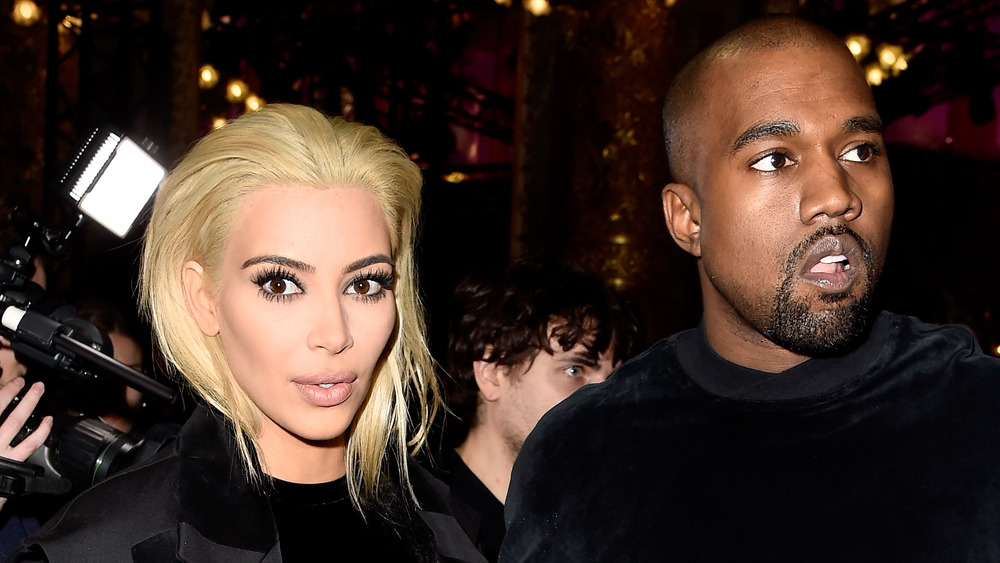 A blonde Kim Kardashian and Kanye West attend the Balmain show as part of the Paris Fashion Week in March 2015.