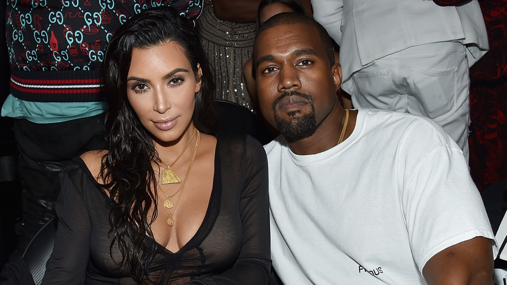 Kim Kardashian and Kanye West looking serious at a fashion show 