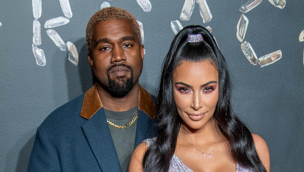 Kanye West and Kim Kardashian looking smug at a Versace show 