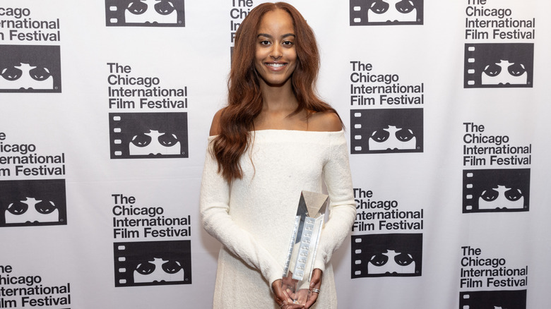 Malia holding an award