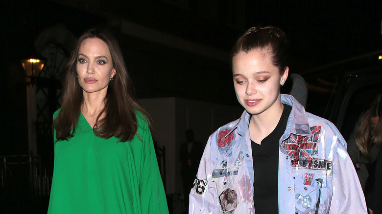 Shiloh Jolie-Pitt walks with Angelina Jolie