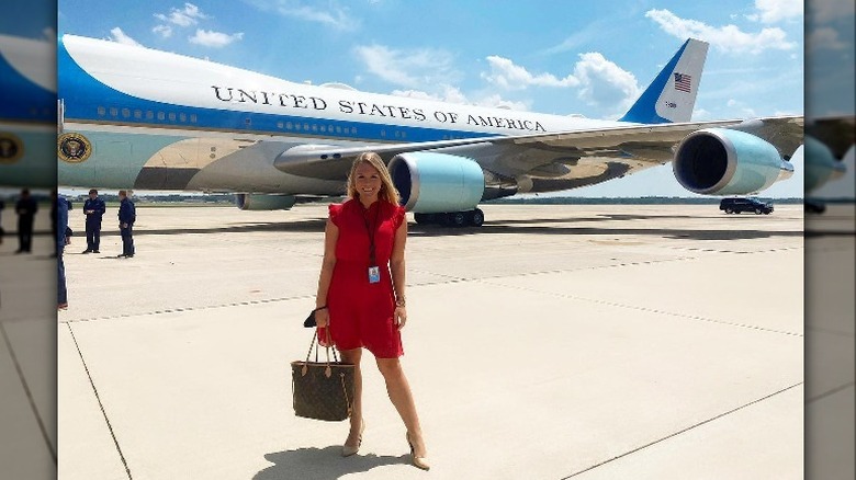 Karoline Leavitt standing in front of a plane