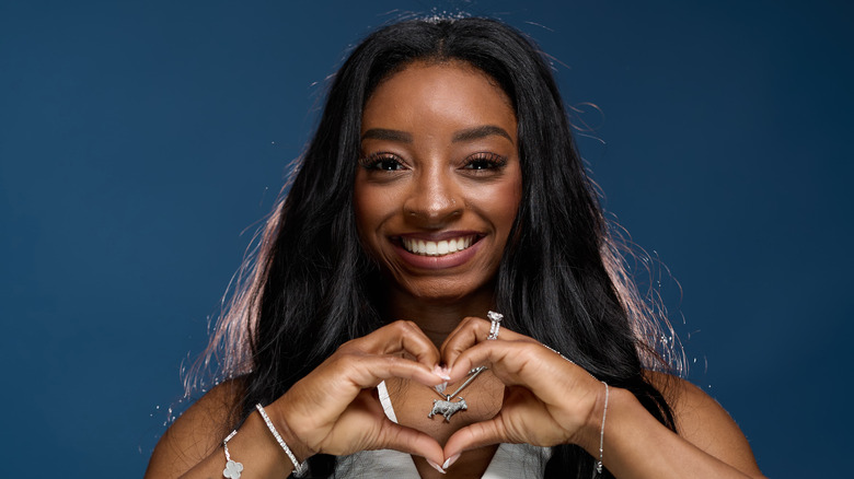 Simone Biles making hand heart