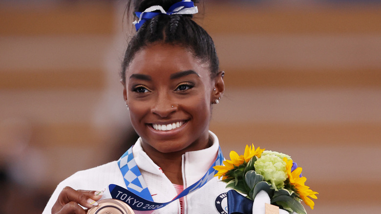 Simone Biles with her bronze medal