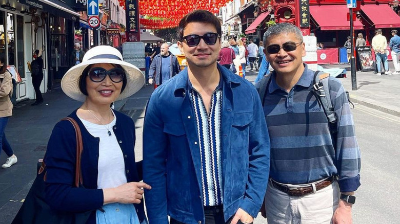 Simu Liu and his parents pose in Chinatown London