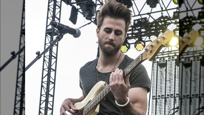 Colton Swan playing guitar on stage