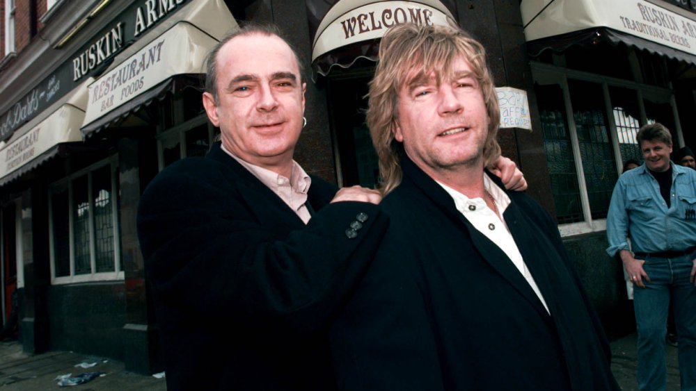 Status Quo members Rick Parfitt and Francis Rossi posing together and smiling