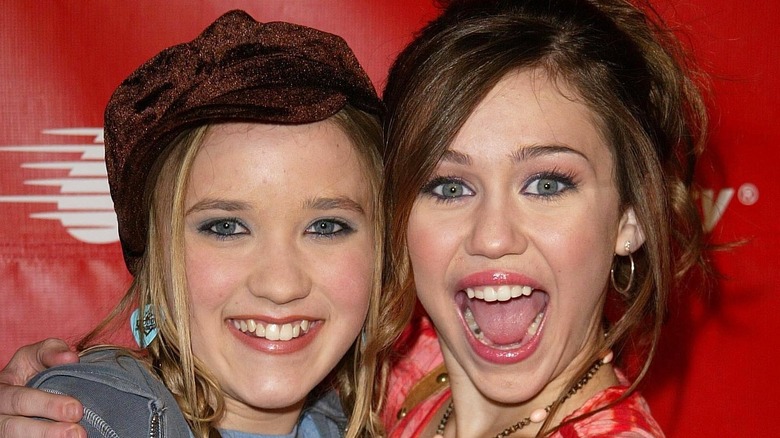 Miley Cyrus and Emily Osment smile 