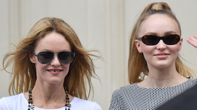 Lily-Rose Depp and Vanessa Paradis smiling in sunglasses