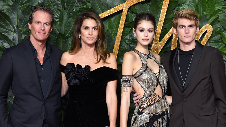 Rande Gerber, Cindy Crawford, and Kaia and Presley Gerber posing at an event