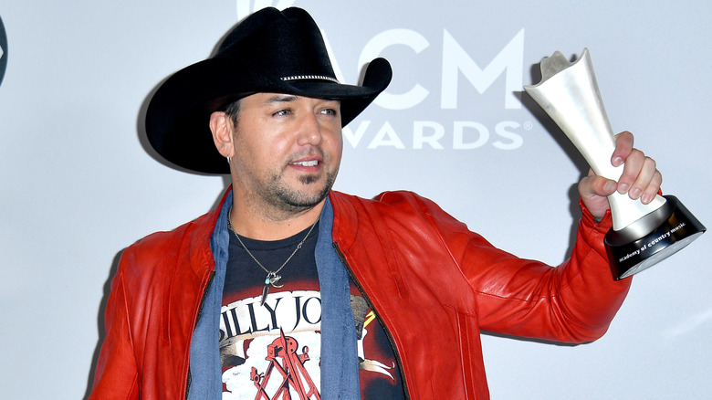 Jason Aldean holding award