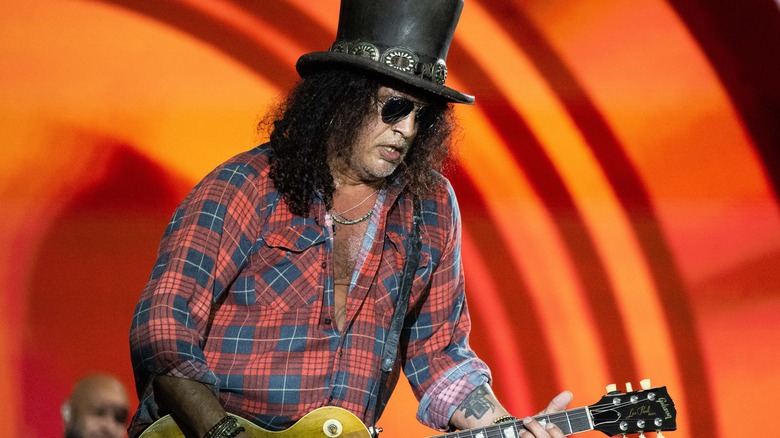 Slash plaid shirt playing guitar