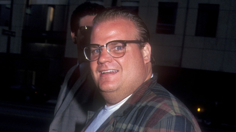 Chris Farley wearing glasses and plaid shirt