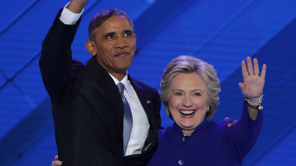 Barack Obama and Hilary Clinton waving 