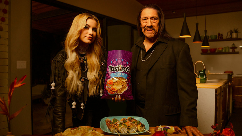 Sofia Reyes and Danny Trejo with Tostitos bag