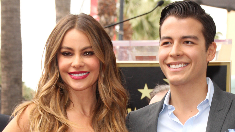 Sofia and Manolo Vergara smiling for cameras outdoors